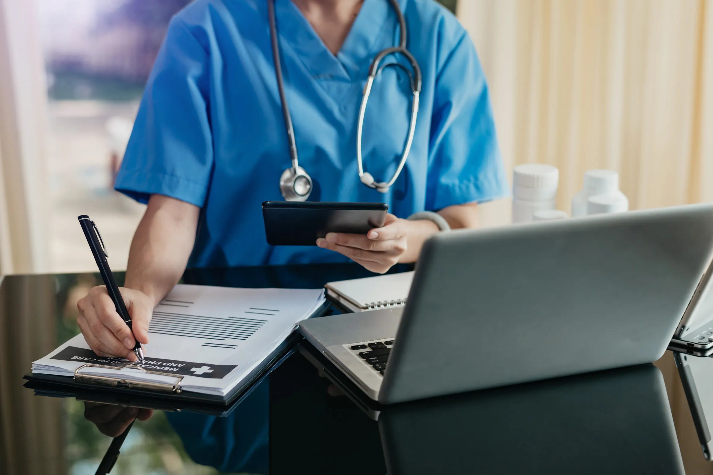 Clinician preparing a structured care plan on a laptop
