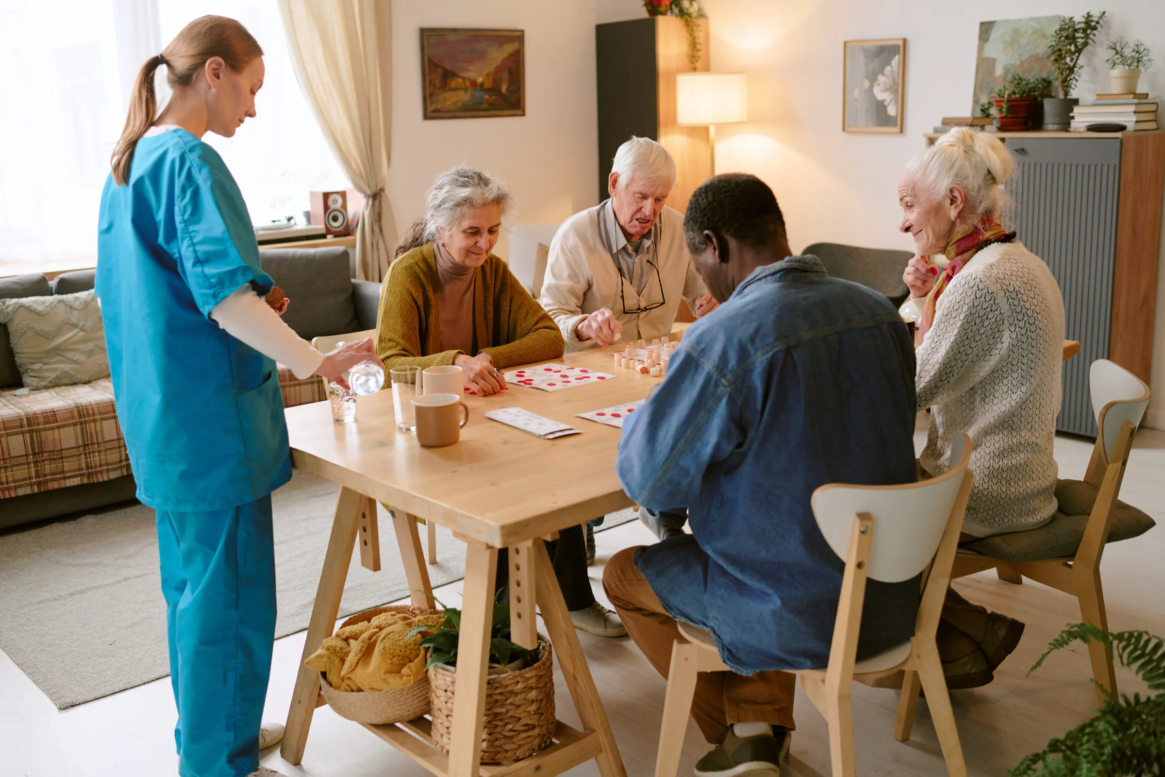 Care staff and residents together in an aged care facility common room